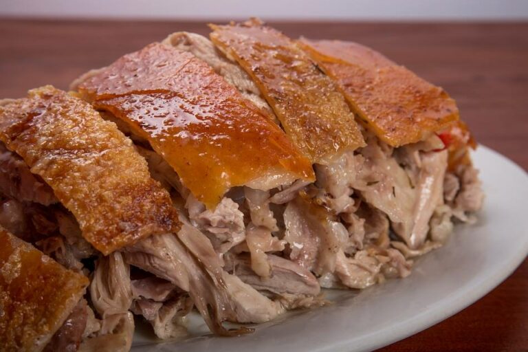 What is the difference between lechon and pernil?